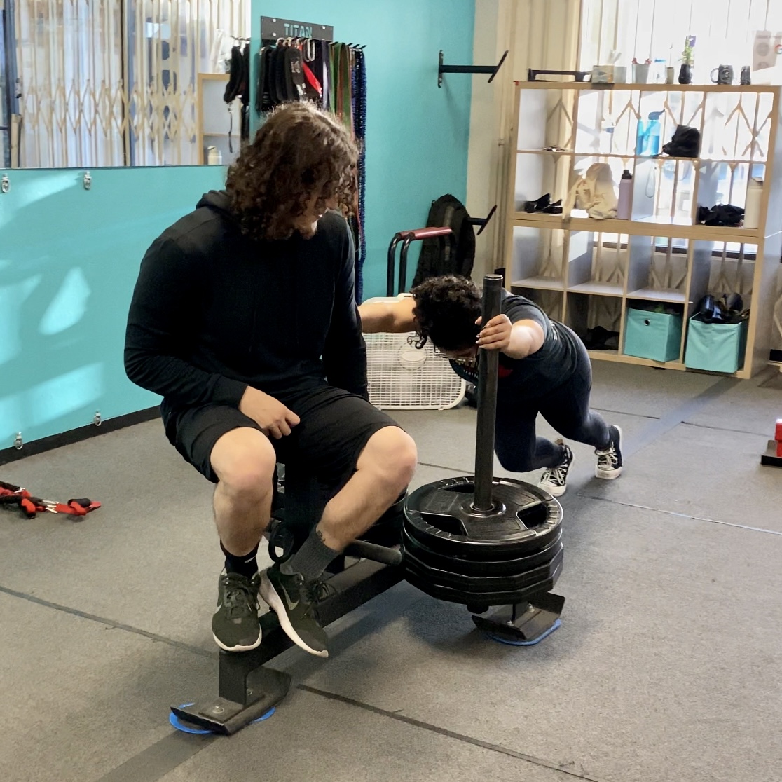 Female pushing sled, strength training